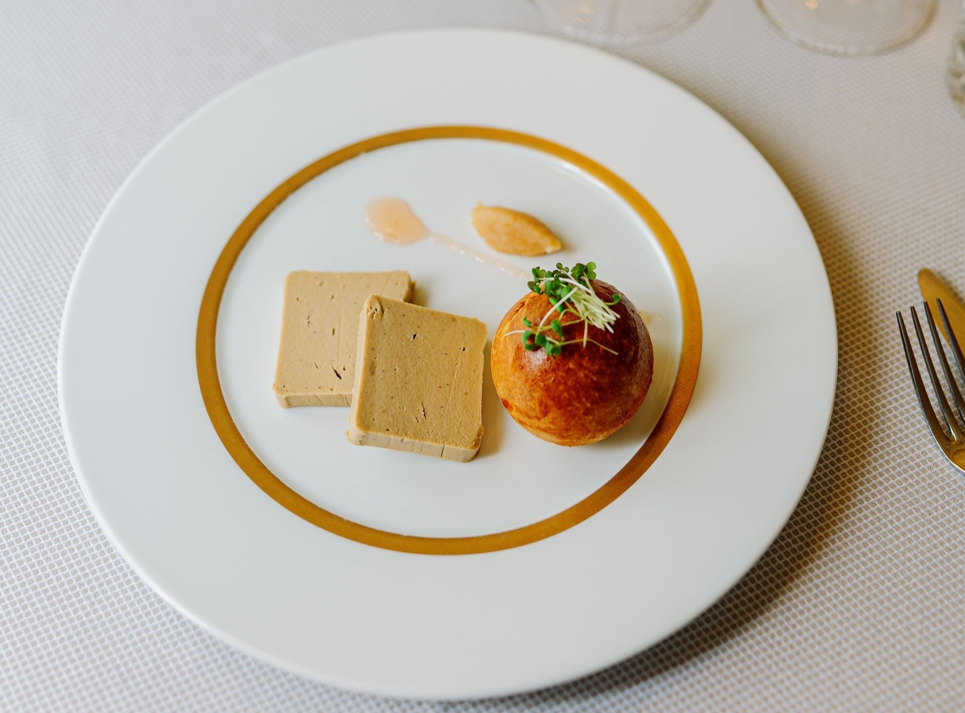 a white plate topped with foie gras