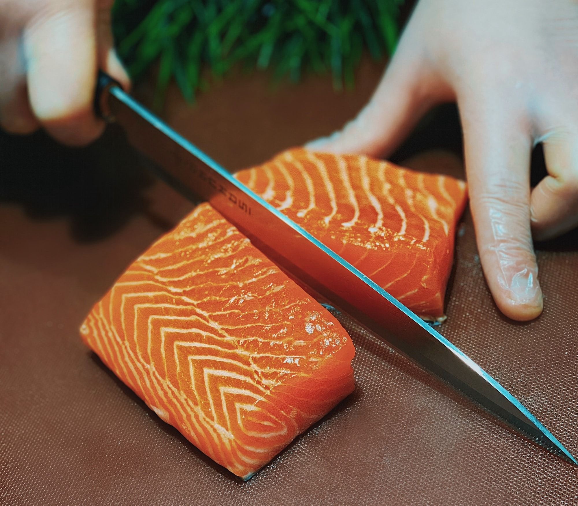 Salmon being sliced into half