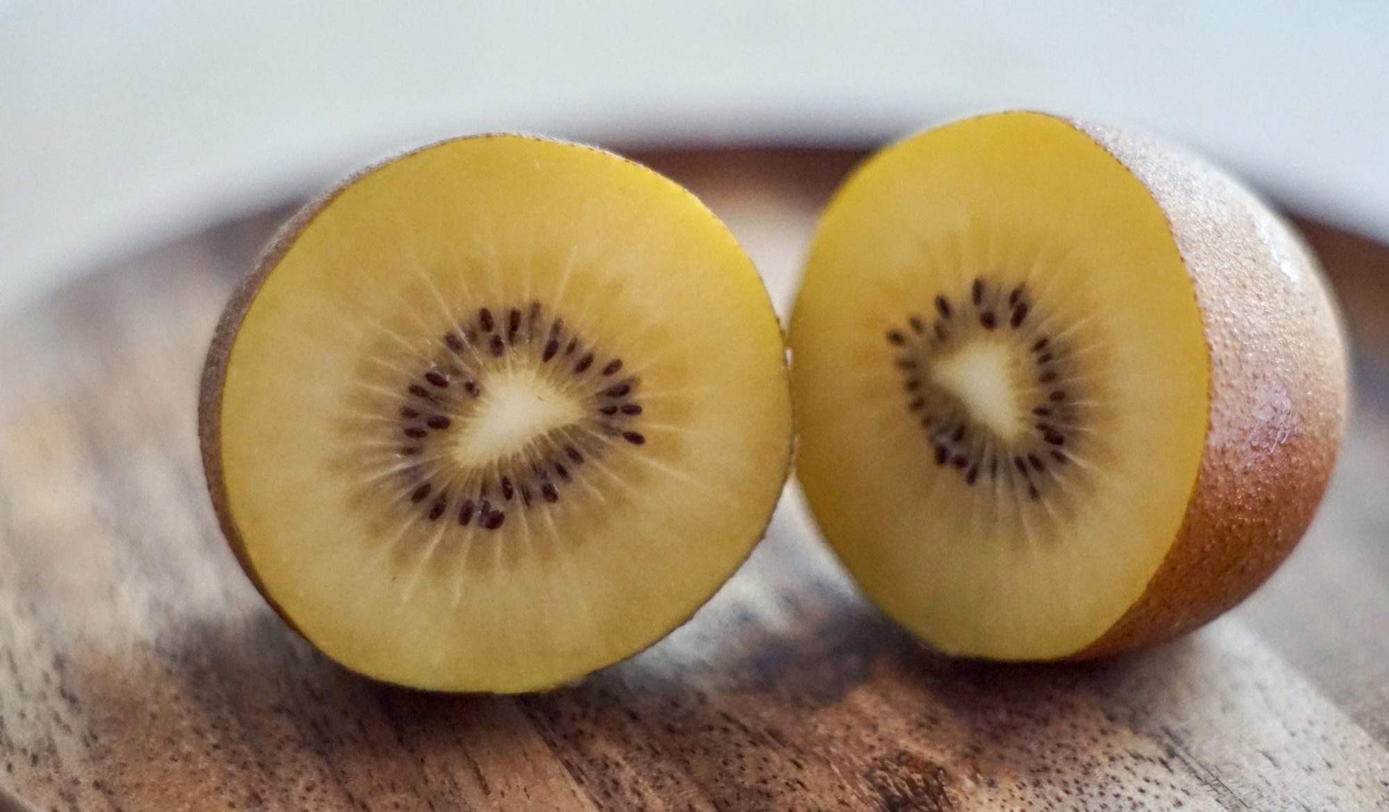 sliced yellow fruit on brown wooden table