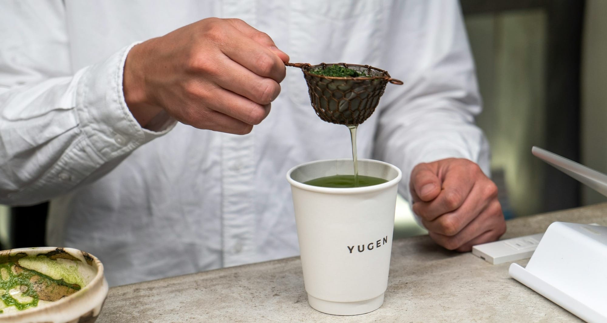 person holding green ceramic mug