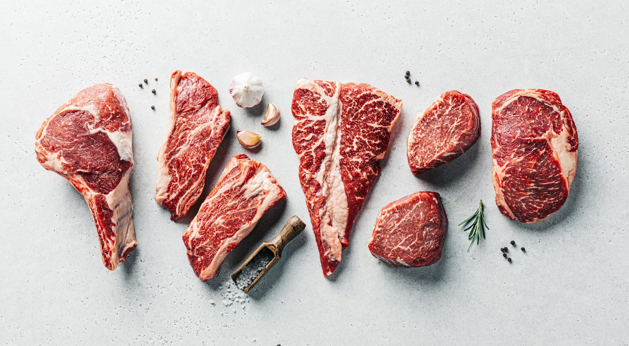 a group of raw meats on a table