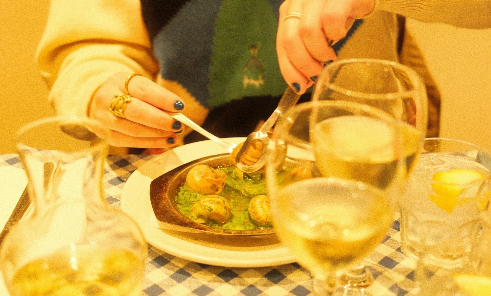 a woman sitting at a table with a plate of food